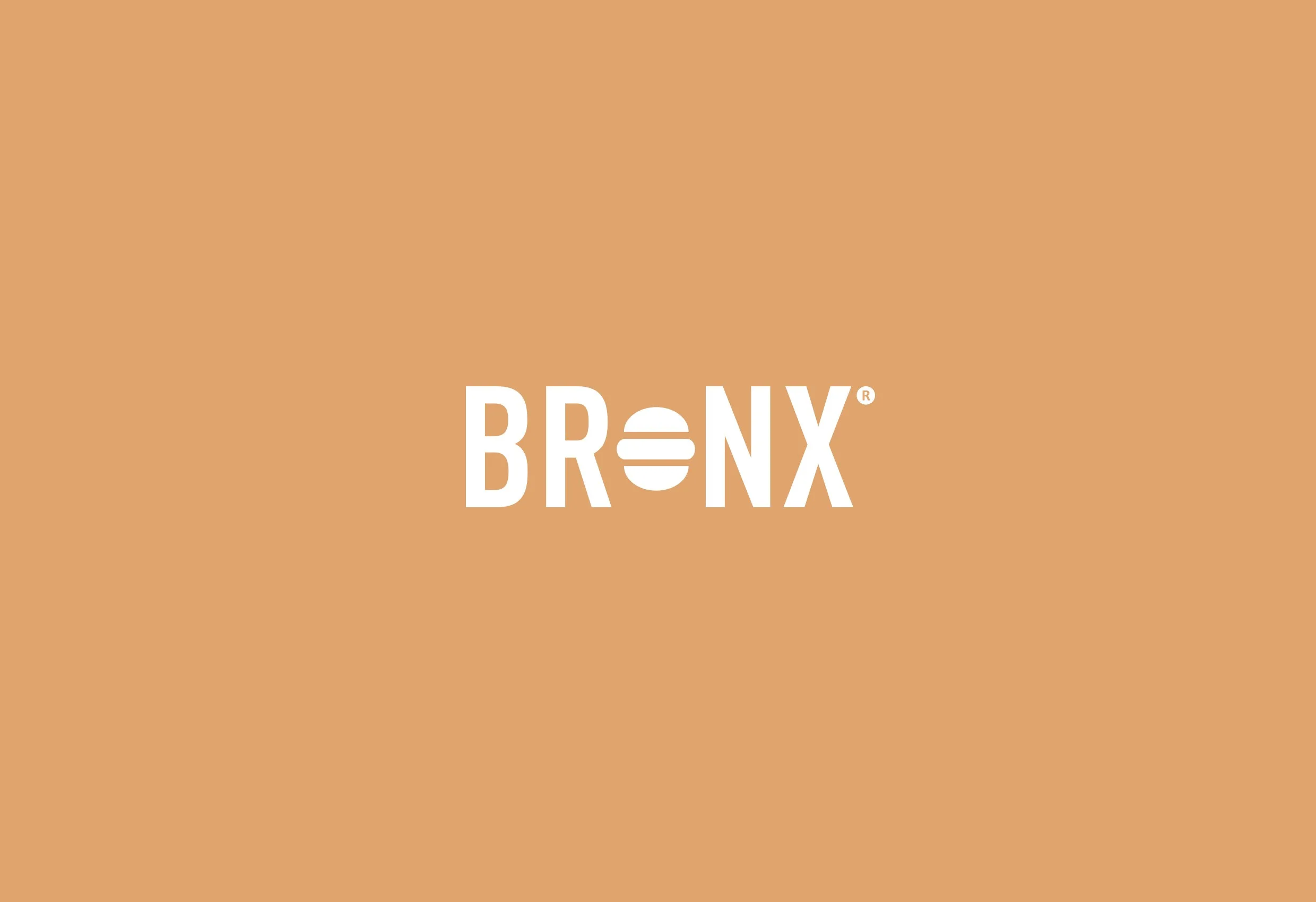 Bronx logotyp i vitt på orange botten