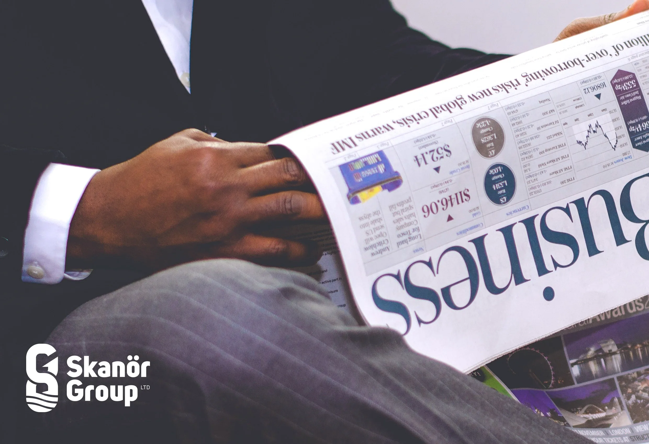 En person i kostym som läser en tidning med ordet ”business”, med Skanör Groups logotyp nere till vänster