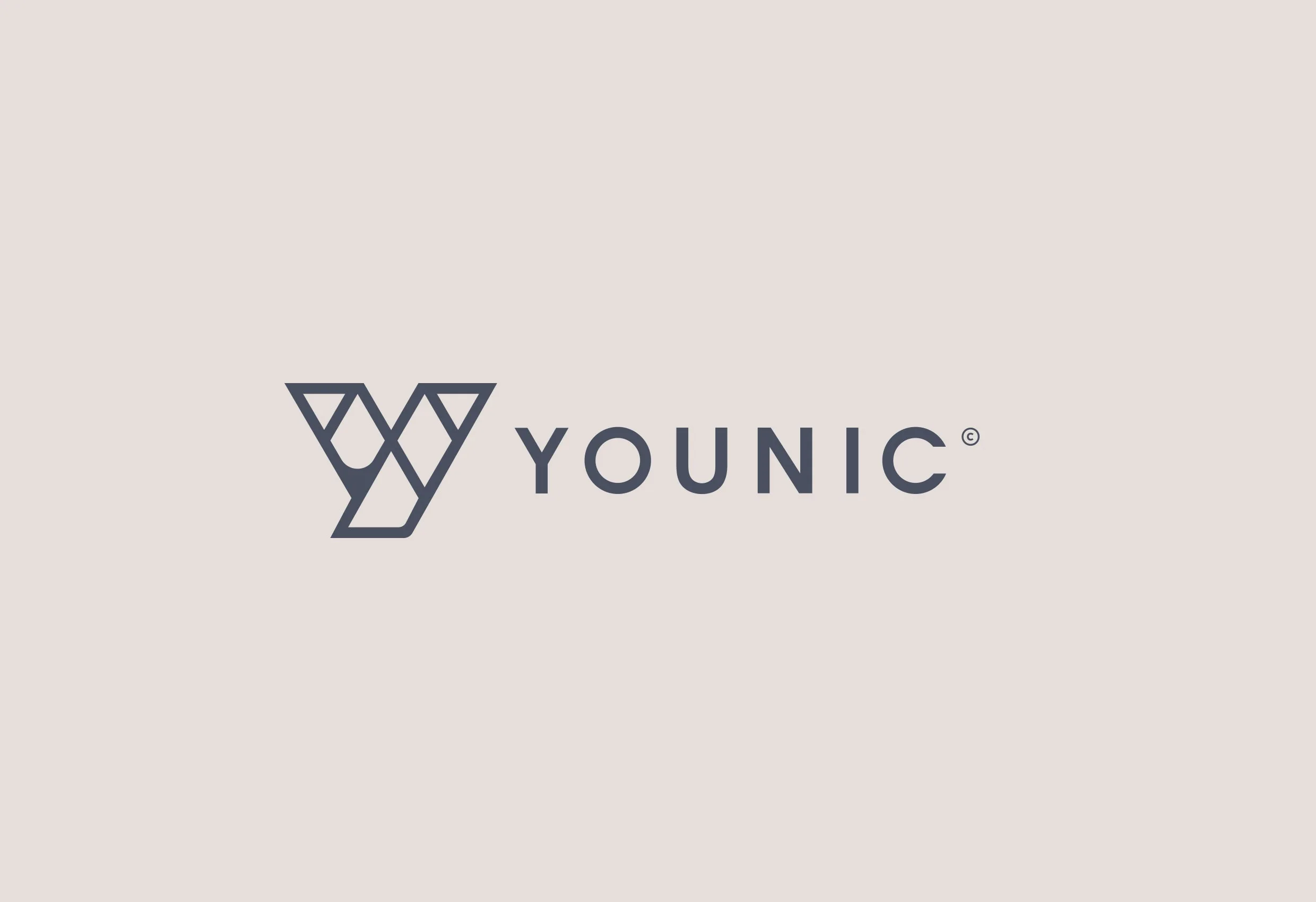 Younics logotyp, ett Y av trianglar och ordet ”Younic”, i mörkblått på ljus rosa bakgrund